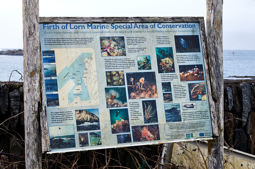 Ellenabeich, Seil, Argyll & Bute, Scotland. 20th Feb 2024. Information notice with advice on the Firth of Lorn Marine Special Area of Conservation on the pier of Ellenabeich, Seil, Argyll and Bute, Scotland