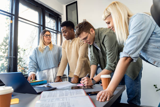 istock Diverse group of young people working on new project together in office. 2075878495