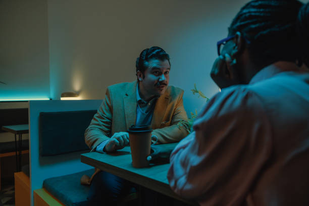 istock Colleagues sitting in the office cafeteria during nighttime 2075879586