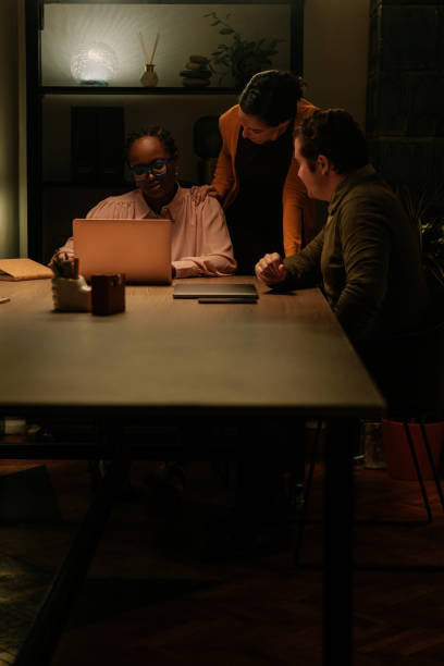 istock Three business associates discussing late at night 2075880100