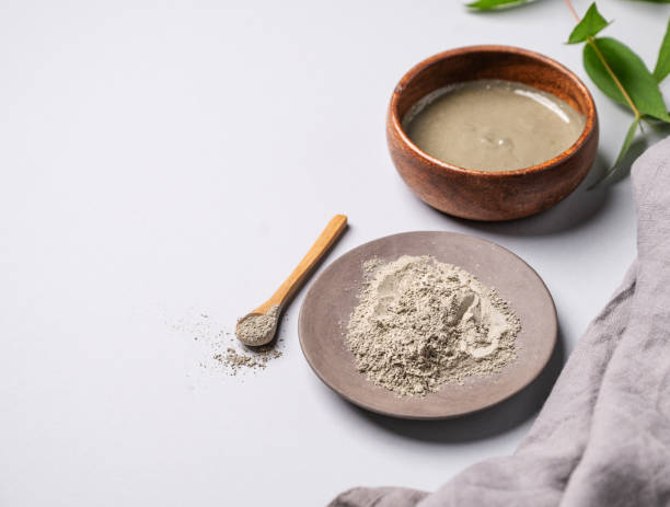 istock Blue clay in a bowl on a light background with branch and napkin. Concept for preparing homemade skincare organic cosmetics 2075893892