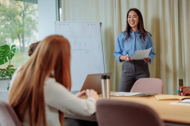 istock Businesswoman smiling while holding a business presentation 2075908088