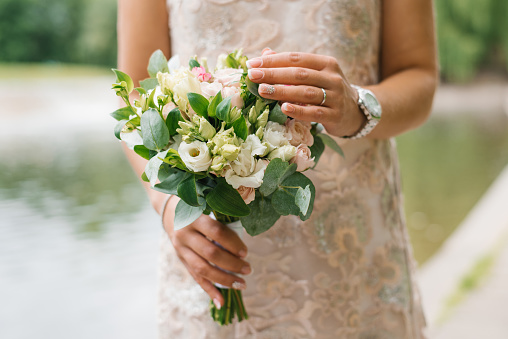Beautiful rustic wedding bouquet in the hands of the bride