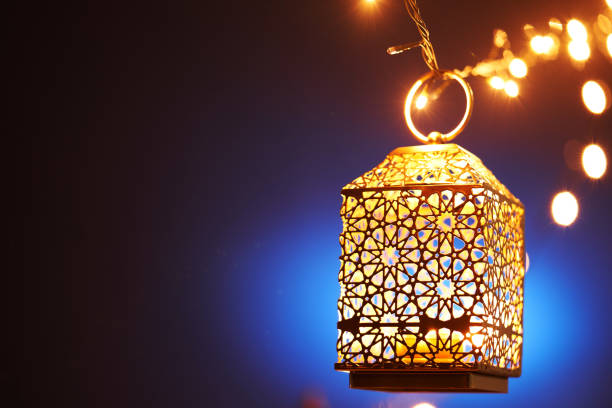 istock Ramadan decoration illuminated arabic lantern against blue background 2075915585