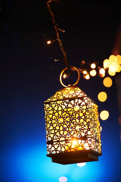 istock Ramadan decoration illuminated arabic lantern against blue background 2075915588