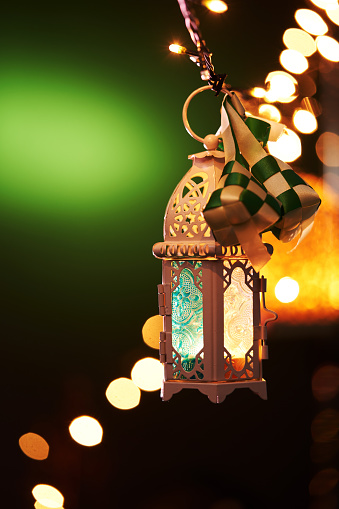 ribbon ketupat Arabic lantern on green and blue background