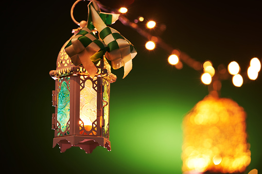 ribbon ketupat Arabic lantern on green and blue background