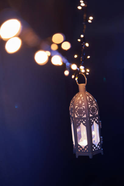 istock Ramadan decoration illuminated arabic lantern against blue background 2075919283