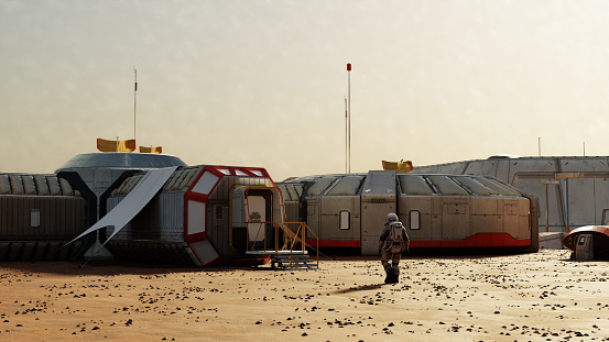 Astronaut approaches a Martian base with modular structures under a dusty sky, colonization. 3d render