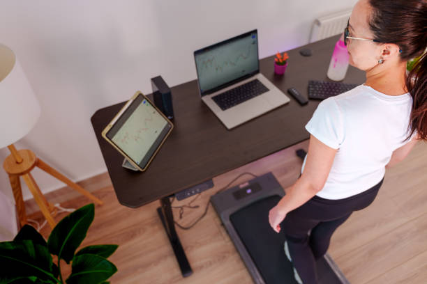 istock Woman at home office is walking on under desk treadmill 2075925601