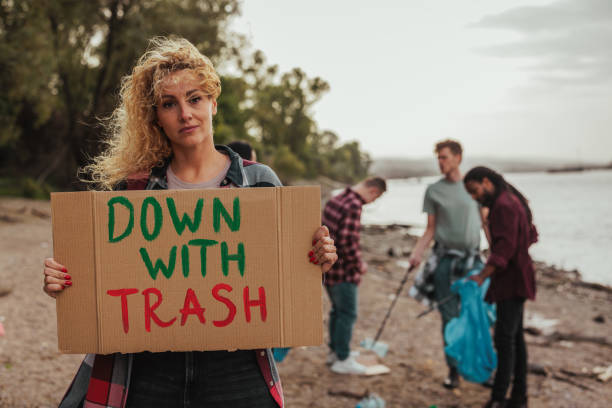 istock Female volunteer with a placard message on earth day 2075926640