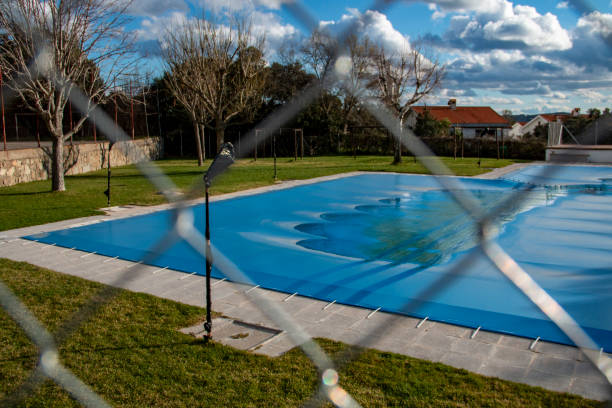 istock Swimming pool covered with a blue tarp ready to spend the winter 2075929822