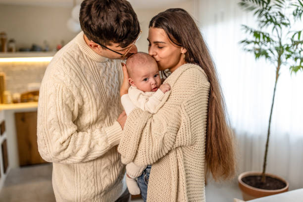 istock Young parents couple holding and hugging baby boy at home 2075934607