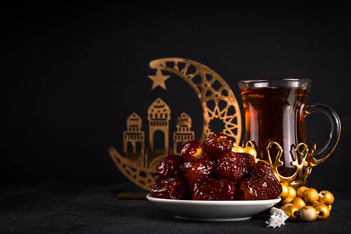 Ramadan Kareem background, Dates fruit, tea and rosary beads. Flat lay background with copy space for Ramadan greetings