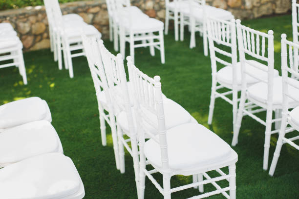 Beautiful white wedding chairs at the ceremony in the Park..