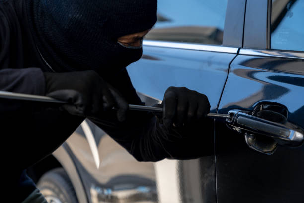 istock A thief is trying to force open a car door 2075969619