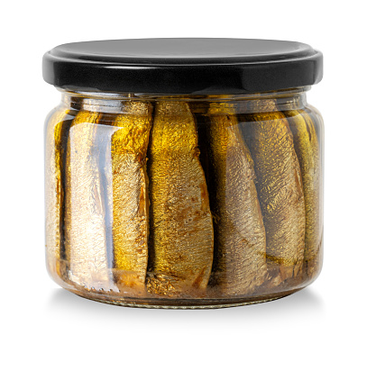 Sardines with oil conserved in glass jar isolated on the white background