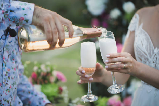 istock The bridegroom pours champagne in glasses. 2076016533