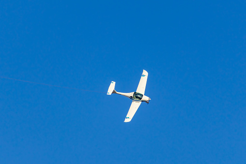 Ultralight plane with prolonge fyling on blue sky. Aviation background
