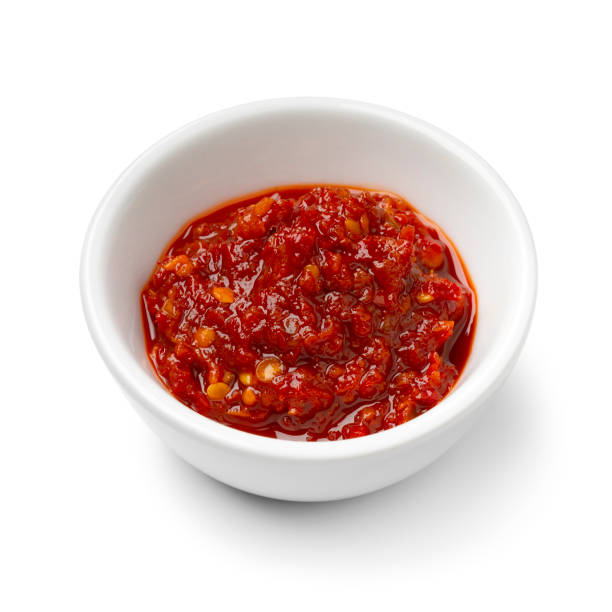 istock Single white bowl with sambal sauce on white background close up 2076027780