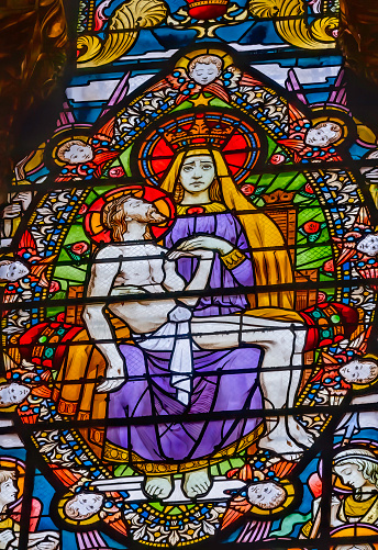 Pieta Virgin Mary Crucified Jesus Colorful Stained Glass Basilica of Notre Dame de Fourvière Lyon France. Built from 1872 to 1896. Dedicated to Virgin Mary.