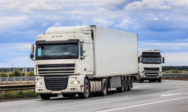 istock Trucks moving along a country road 2076096137