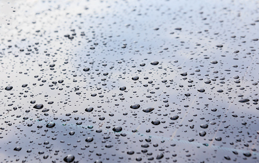 Water drops on car glass close-up background