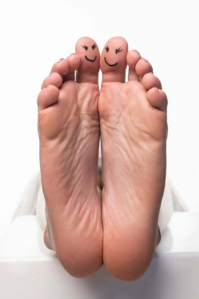 istock Closeup of a female toes with a smile drawn on them. 2076120719