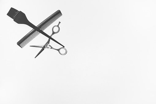 Hairdresser tools on the white background with copy space. Hairstyling accessories.