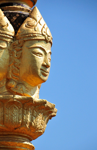 Vientiane, Laos:  Patuxai (literally Victory Gate or Gate of Triumph) - golden finial - commonly known as the four-faced Buddha, this is actually a representation of the creator god Brahma (Mahabrahma), worshipped outside of Hindu contexts by regular Buddhists - Patuxay was completed in 1968 to celebrate independence from France (1949). In 1995 it was renamed by the communists of Pathet Lao to celebrate their victory in the civil war, and dedicated to “The Heroes of August 23, 1975” (Day of the Communist seizure of power).