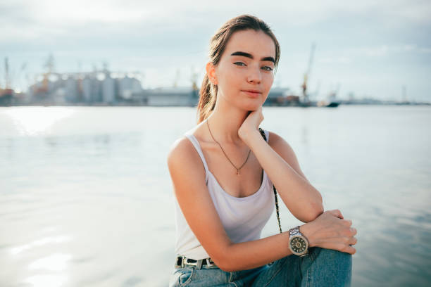 istock A woman in a white tank top and blue jeans 2076135899