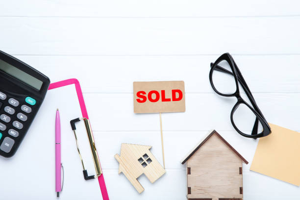 istock House models with calculator, clipboard and glasses on wooden table 2076135901