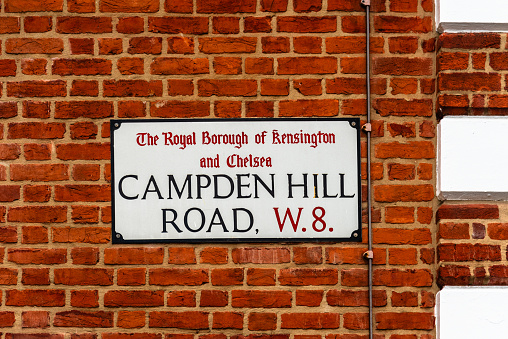 London, UK - August 26, 2023: Campden Hill Road street name sign on brick wall. The Royal Borough of Kensington and Chelsea