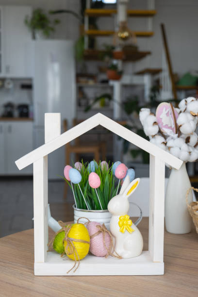 istock Tiny house of cozy home with Easter decor with rabbit and eggs on table of kitchen. Building, design, project, moving to new house, mortgage, insurance, rent and purchase real estate 2076140161