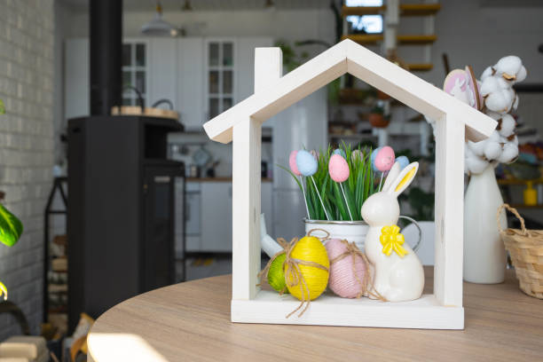 istock Tiny house of cozy home with Easter decor with rabbit and eggs on table of kitchen. Building, design, project, moving to new house, mortgage, insurance, rent and purchase real estate 2076140165