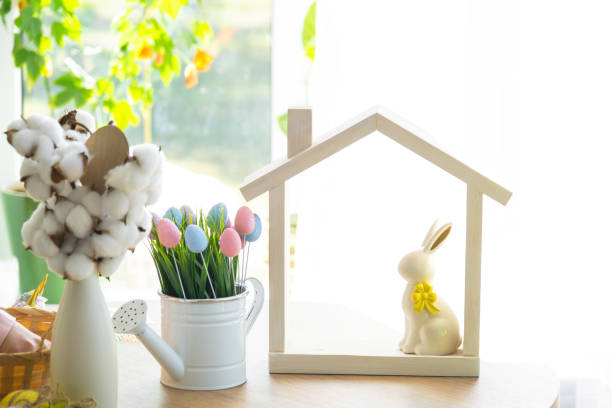 istock Tiny house of cozy home with Easter decor with rabbit and eggs on table of kitchen. Building, design, project, moving to new house, mortgage, insurance, rent and purchase real estate 2076140169