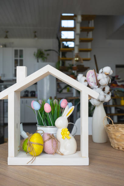 istock Tiny house of cozy home with Easter decor with rabbit and eggs on table of kitchen. Building, design, project, moving to new house, mortgage, insurance, rent and purchase real estate 2076140170