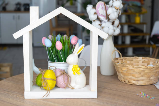 istock Tiny house of cozy home with Easter decor with rabbit and eggs on table of kitchen. Building, design, project, moving to new house, mortgage, insurance, rent and purchase real estate 2076140171