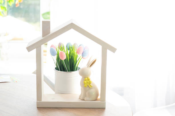 istock Tiny house of cozy home with Easter decor with rabbit and eggs on table of kitchen. Building, design, project, moving to new house, mortgage, insurance, rent and purchase real estate 2076140678