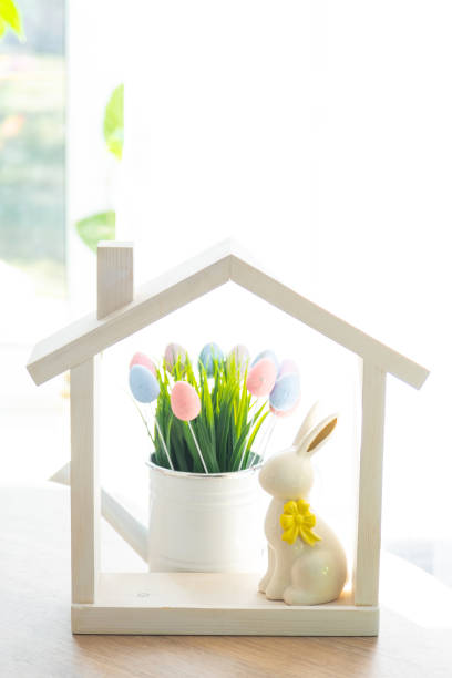 istock Tiny house of cozy home with Easter decor with rabbit and eggs on table of kitchen. Building, design, project, moving to new house, mortgage, insurance, rent and purchase real estate 2076140680
