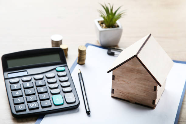 istock House model with calculator and coins on wooden table 2076144079
