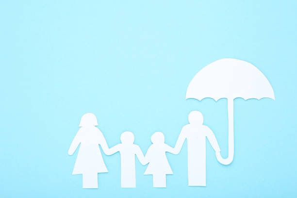 istock Paper family figures with umbrella on blue background 2076169449
