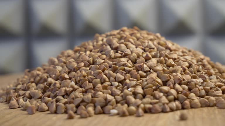 Rotating raw buckwheat. Buckwheat close-up. Сlose up uncooked seeds.