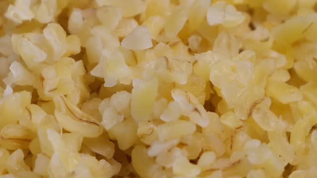 Boiled bulgur grits, close-up. Bulgur porridge, full frame. Vegetarian Healthy Organic Food