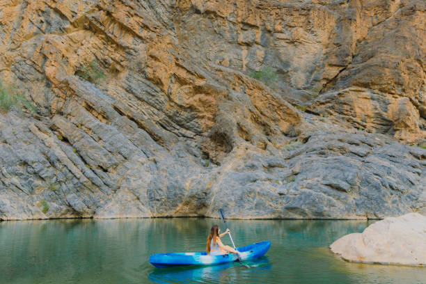 istock Woman Kayaking at Scenic Canyon During Sunset 2076227220