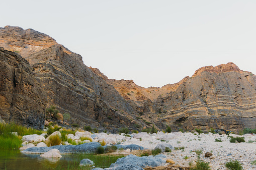 Scenic views of magnificent canyon with mountain river hidden in the mountains of Oman, Middle East