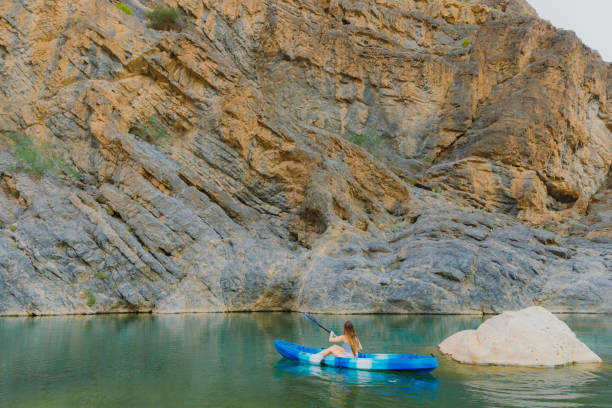 istock Woman Kayaking at Scenic Canyon During Sunset 2076228820