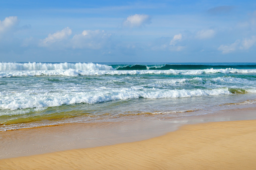 Scenic tropical beach and sky with beautiful cumulus clouds.