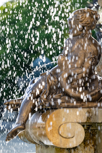 Bronze sculpture of child with motion blurred water, detail of the Ganymede fountain unveiled in 1888 by Viktor Tilgner in public square of Bratislava Old Town