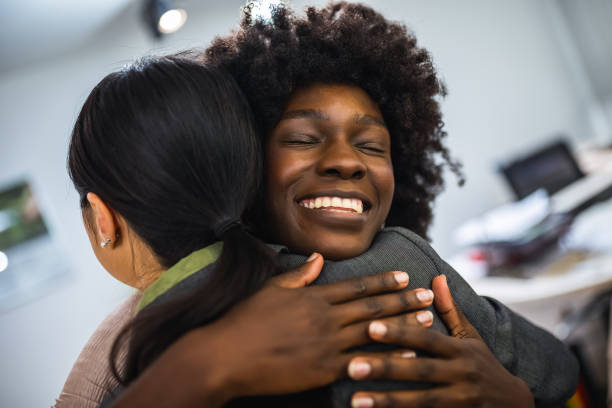 istock Multiethnic group of coworkers hugging at a group therapy session, overcoming problem together. 2076278010